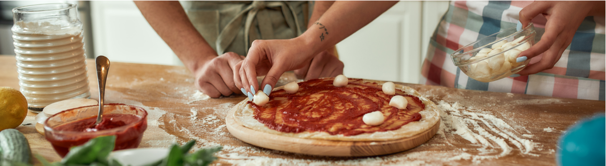 Two people making pizza